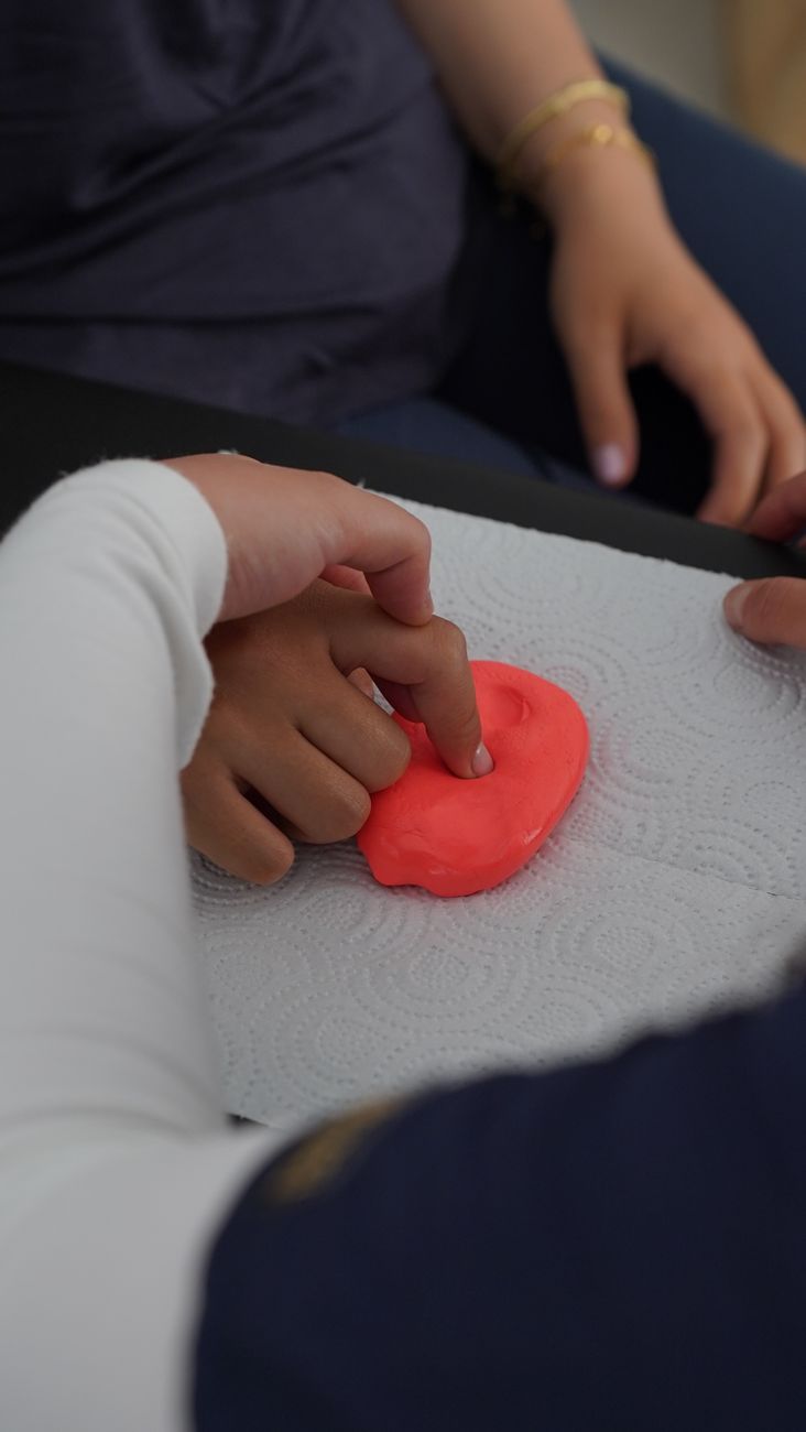 A clinician and child working together at a table
